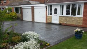 Platinum Grey Grand Ashlar Printed Concrete Driveway with Etched Borders and Compass Feature