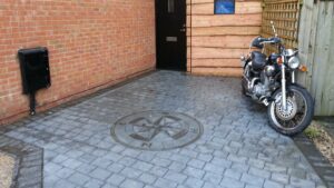 Platinum Grey London Cobble Printed Concrete Driveway with Charcoal Etching and Compass Feature